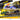 Ramp Truck #80 Dark Gray Metallic with Gold Metallic Stripes "JDM Garage" and 1980 Datsun 280ZX (S130) #80 Green Metallic with Stripes "Elite Transport" Series 1/64 Diecast Models by Maisto